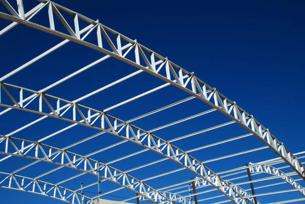 Steel roof trusses against a blue sky
