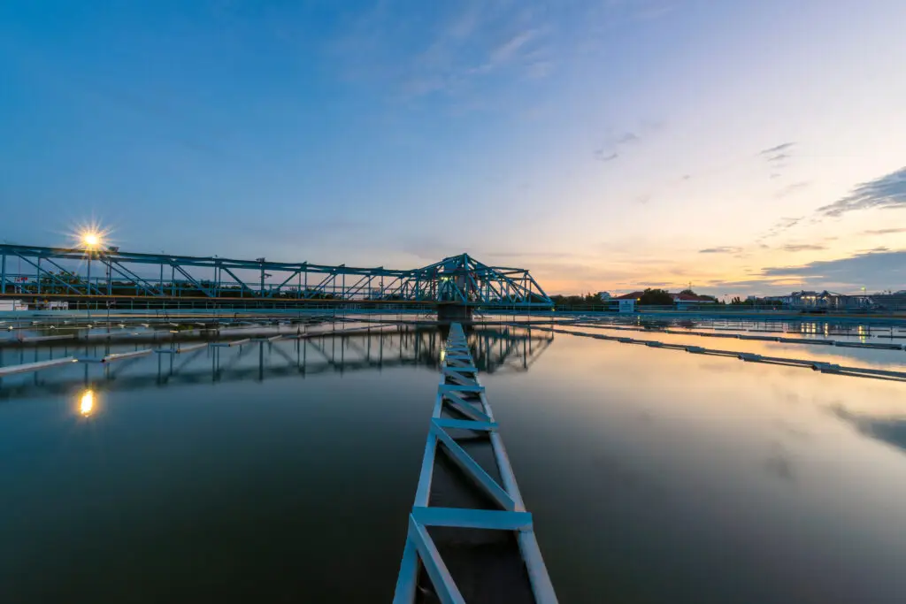 Water treatment plant tanks at sunset