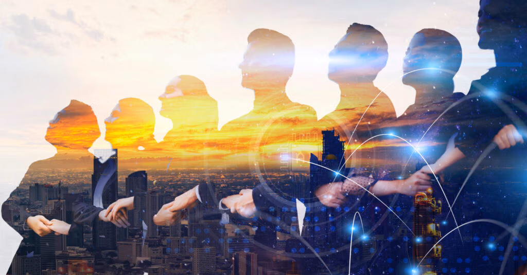 Silhouettes of business people overlaid on a city skyline at sunset