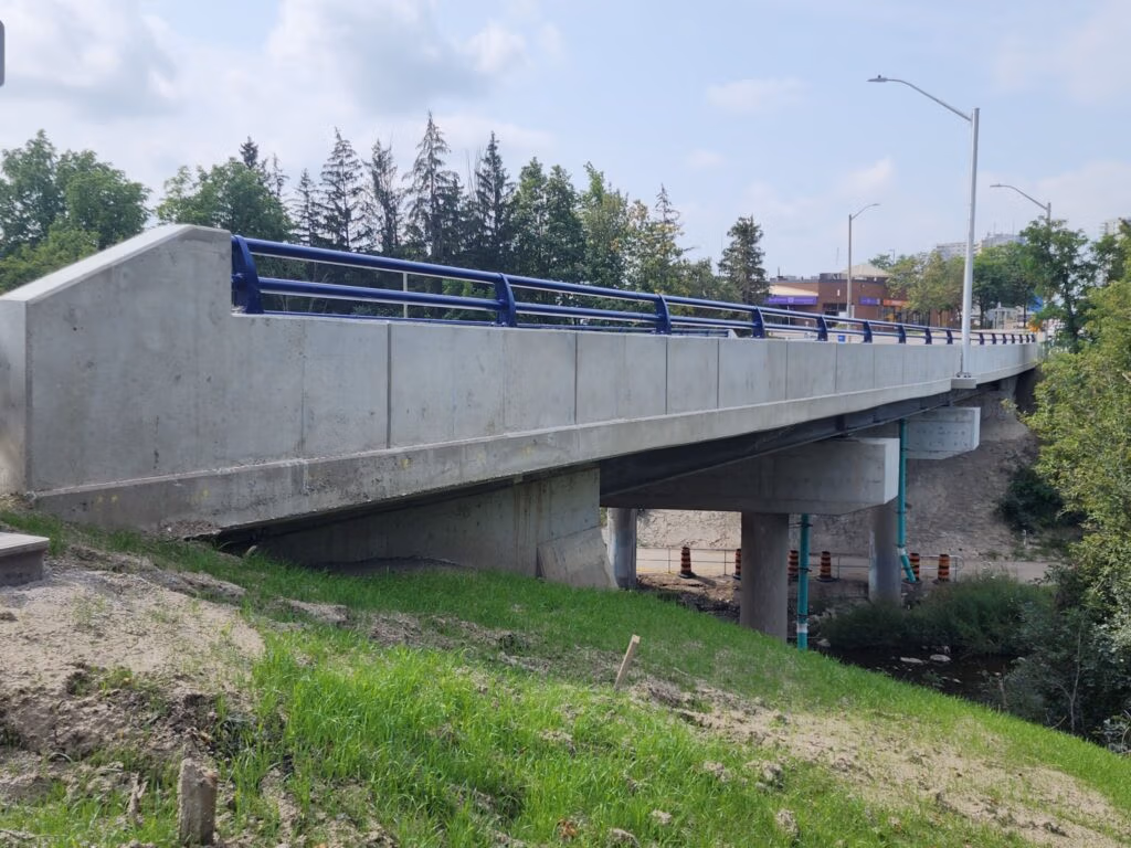 Rehabilitated concrete bridge with blue railings in Brampton