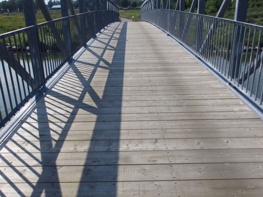 Pedestrian bridge with a wooden deck and steel railings, City of Oshawa biennial inspections