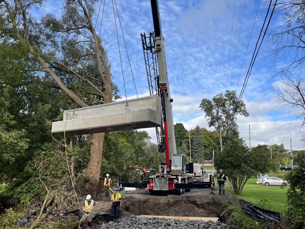 Crane lifting a precast concrete girder into place